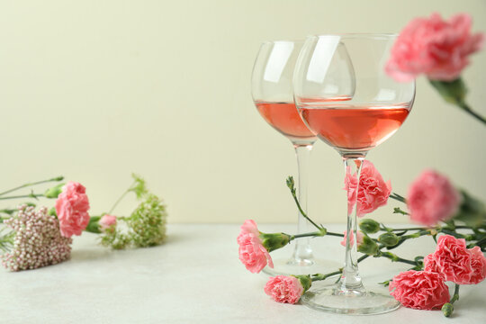 Glasses of pink wine and beautiful flowers