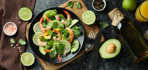 Concept of tasty eating with shrimp salad on black smokey background
