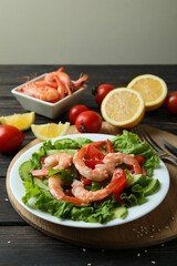 Concept of tasty eating with shrimp salad on wooden table