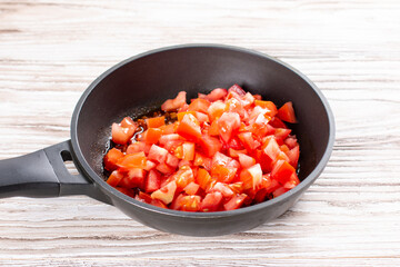 Tomatoes and spices in a pan. Chicken kadhai. Indian chicken curry. Cooking step by step