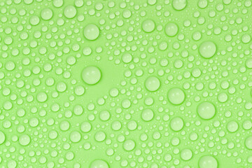 Water drops on green background texture. Backdrop glass covered with drops of water. green bubbles in water.