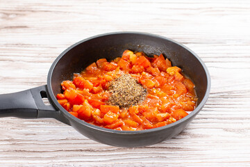 Tomatoes and spices in a pan. Chicken kadhai. Indian chicken curry. Cooking step by step