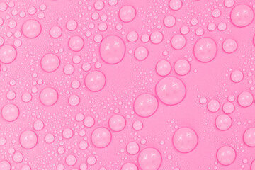 Water drops on pink background texture. Backdrop glass covered with drops of water. scarlet bubbles in water.