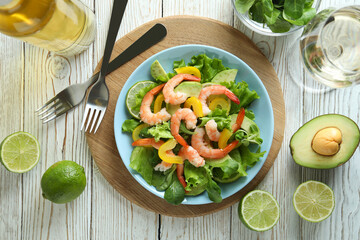 Concept of tasty eating with shrimp salad on wooden table