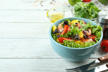 Concept of tasty eating with shrimp salad on white wooden table