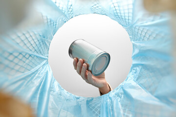 recycling, waste sorting and sustainability concept - hand throwing tin can into rubbish bin
