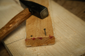 Top view at the wooden table with carpentery tools, hammer and wooden planks