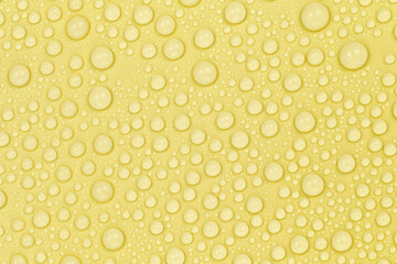 Water drops on yellow background texture. Backdrop glass covered with drops of water. yellow bubbles in water. beer texture