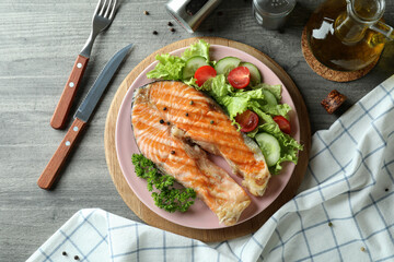 Concept of tasty eating with grilled salmon, top view
