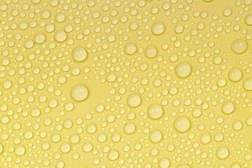 Water drops on yellow background texture. Backdrop glass covered with drops of water. yellow...