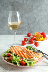 Concept of tasty eating with grilled salmon, close up