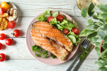 Concept of tasty eating with grilled salmon, top view