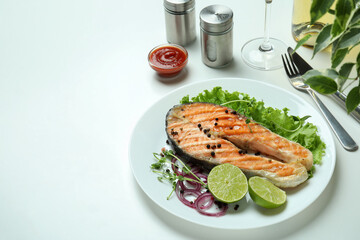 Concept of tasty eating with grilled salmon on white background