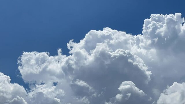 The sky is covered with fluffy cumulus clouds.