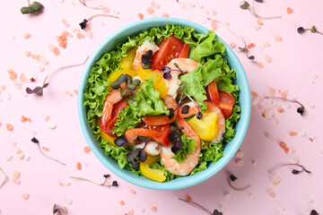 Concept of tasty eating with shrimp salad on pink background