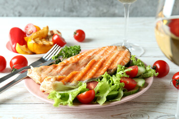 Concept of tasty eating with grilled salmon, close up