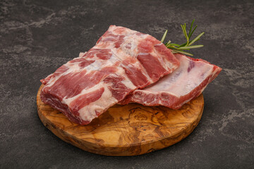 Raw pork ribs served rosemary