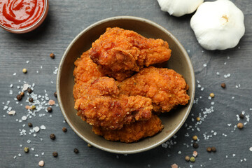 Concept of tasty eating with fried chicken on dark wooden background