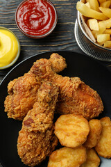 Concept of tasty eating with fried chicken on wooden background