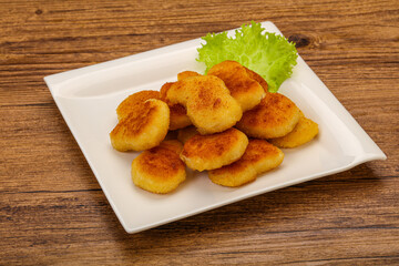 Fried chicken nuggets served salad leaves