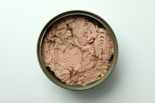 Tin with canned tuna on white background