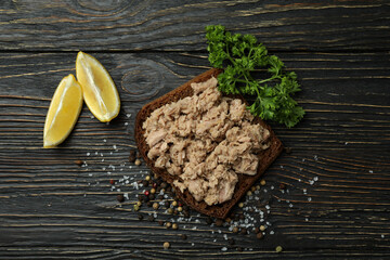 Sandwich with canned tuna on wooden background