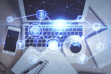 Social network hologram drawings over computer on the desktop background. Top view. Double exposure.