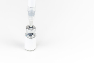 Fototapeta na wymiar medicine bottle empty space label for text and syringe needle injected on white background. medical and treatment concept