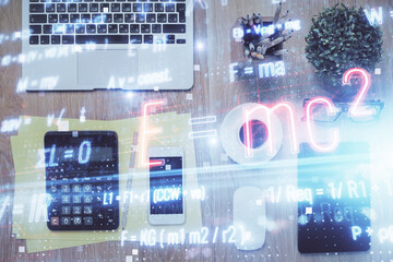 Double exposure of formula drawing over table with phone. Top view. Education concept.