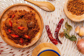 Rendang Pork or Rendang babi. 

Rendang babi is often described as a rich dish of meat  that has been slow cooked and braised in a coconut milk seasoned with a herb and spice mixture.