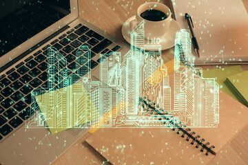Double exposure of buildings drawing and desktop with coffee and items on table background. Concept of smart city