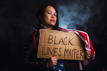 The social problems of racism - Black Lives Matter, woman holding this message.