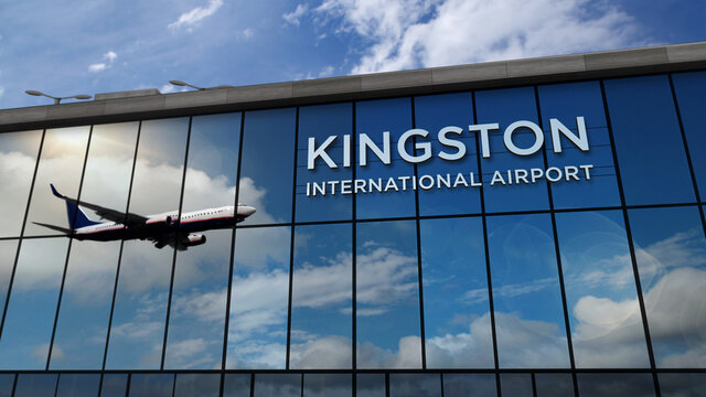 Airplane landing at Kingston Jamaica airport mirrored in terminal