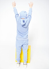 boy showing hands up sign