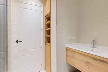 Modern bathroom with wooden base for white sinks. Radiator for warm water procedures in winter....