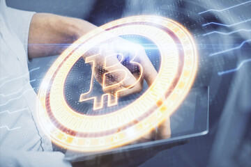 Double exposure of man's hands holding and using a phone and crypto currency blockchain theme...