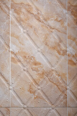 Wet brown marble textured tiles in the bathroom