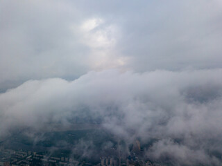 View of Kiev above the clouds at dawn. Aerial drone view.