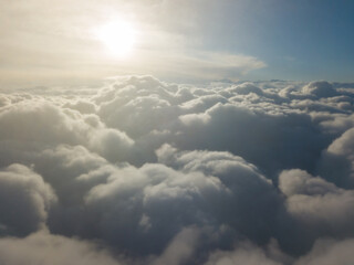 Obraz na płótnie Canvas Aerial high flight above the clouds at sunrise.