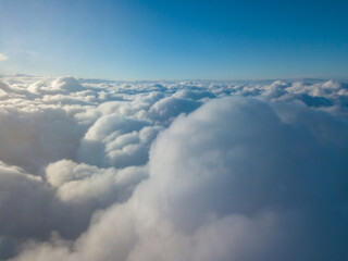 Fototapeta na wymiar Aerial high flight above the clouds at sunrise.