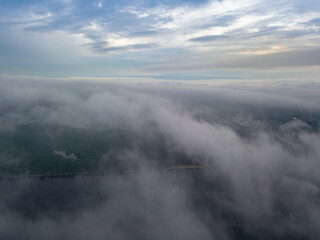 Fototapeta na wymiar High view of the Dnieper River in Kiev. Aerial high flight above the clouds.