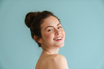 Half-naked brunette woman smiling and looking at camera