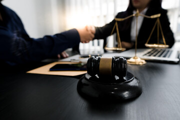 Fototapeta na wymiar Businessman shaking hands to seal a deal with his partner lawyers or attorneys discussing a contract agreement.Legal law, advice, and justice concept.