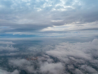 City under the clouds at dawn. Aerial high drone view.