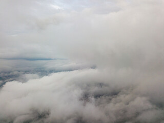 Fototapeta na wymiar Aerial high flight above the clouds.