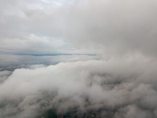 Naklejka na ściany i meble Aerial high flight above the clouds.