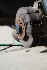 Car service and repair. Tire service. Repair of a broken wheel. Balancing. View of the car on the dock with the wheel removed.