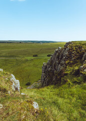 Northumberland UK: Hadrians Wall built on tall cliffs (Roman Wall) on a sunny summer day in English countryside