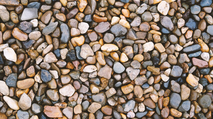 Sea or river multicolored pebbles. Natural texture of beach pebbles. Weathering and erosion of rocks. Drainage systems from small pebbles. Garden drainage for plants and trees. Blue stones for roads.