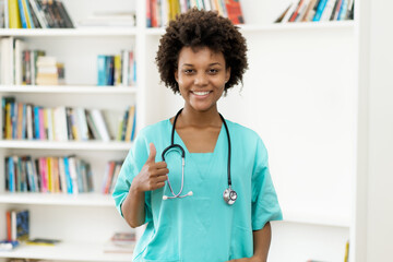 Optimistic afro american female nurse at work